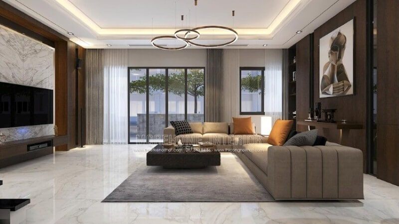 Thiết kế nội thất phòng khách thể hiện vẻ đẹp nổi bật với mọi ánh nhìn. Ngồi trên chiếc sofa êm ái chiêm ngưỡng bức tranh trừu tượng như một ẩn số khiến ta tò mò những giây phút tĩnh lặng hay thay đổi sự quan tâm sang chiếc tivi giúp tầm mắt được nhìn một cách tập trung với cách trang trí khối đá đối vân trắng.